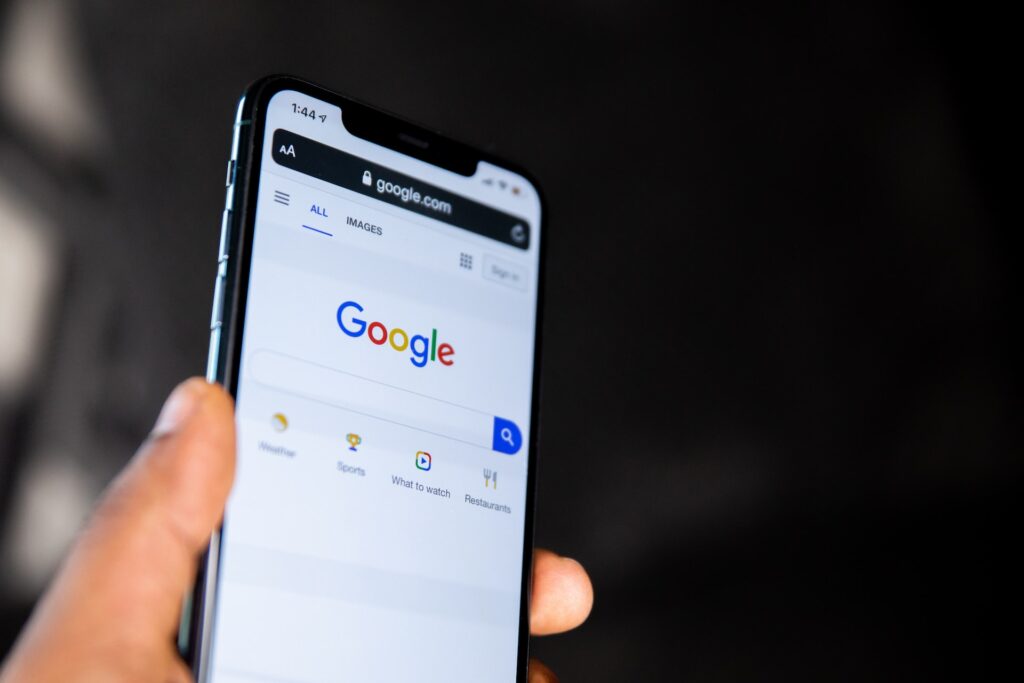 person holding phone open in google