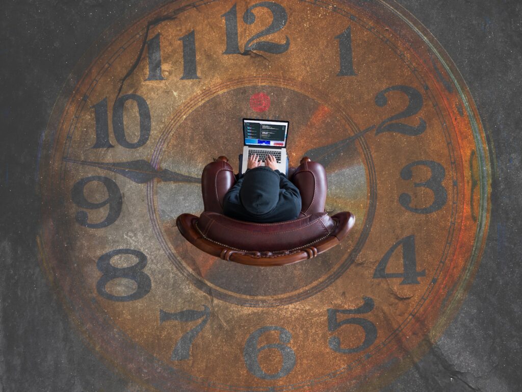 person on computer in clock circle