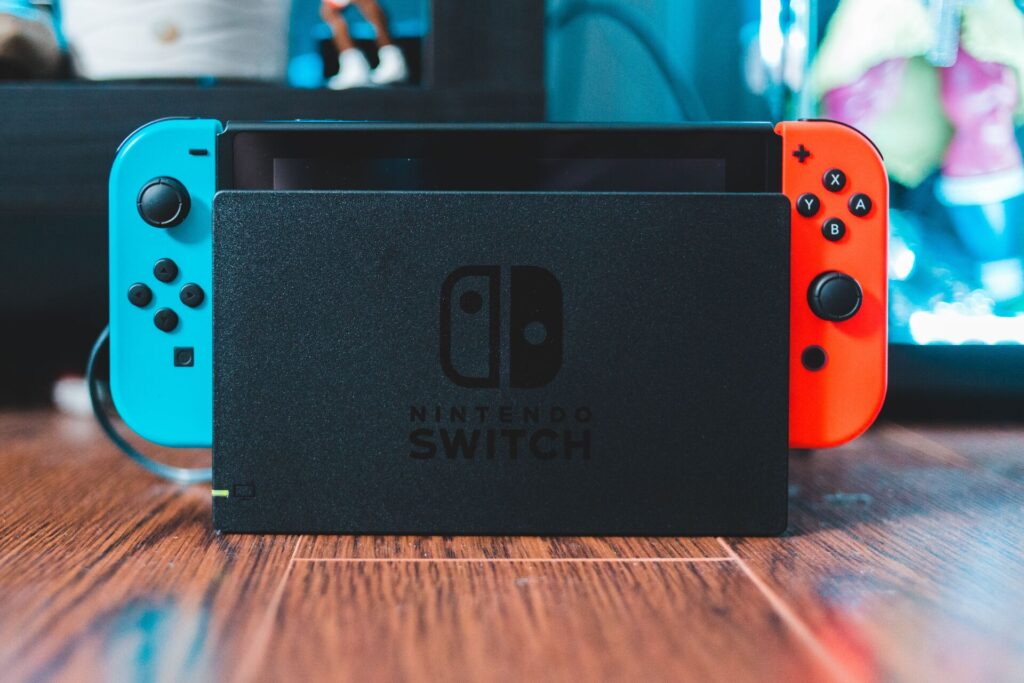 A Nintendo Switch console standing on a table while being docked