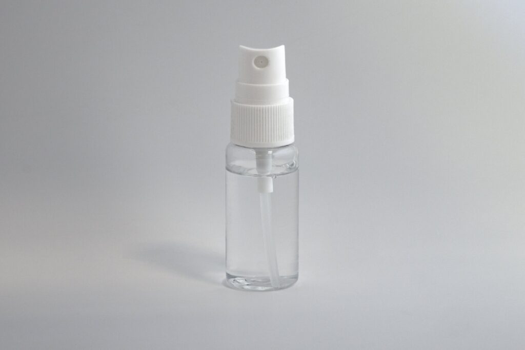 Small spray bottle filled with clear liquid