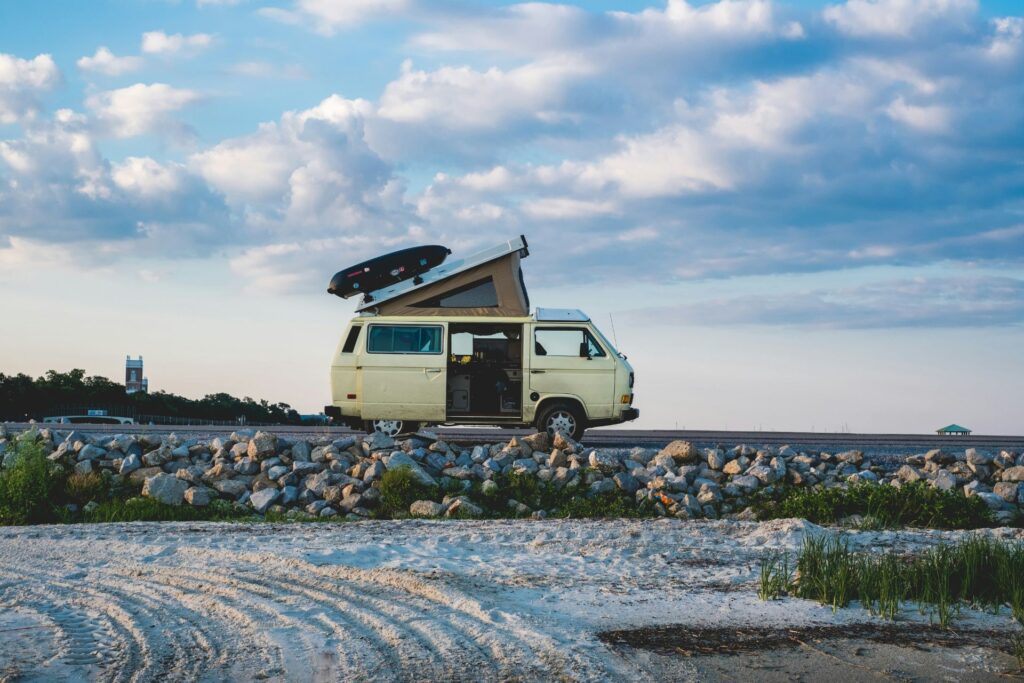 A camper van parked at the beach.