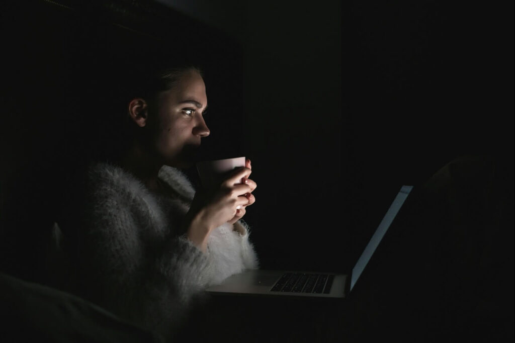 woman using laptop at night