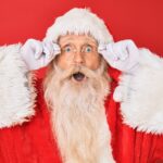 santa claus takes a peak at our best christmas movies list