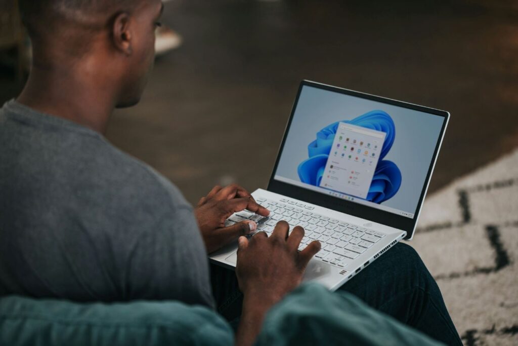 A man using Windows 11 on a laptop