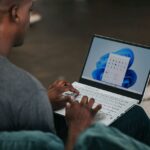 A man using Windows 11 on a laptop