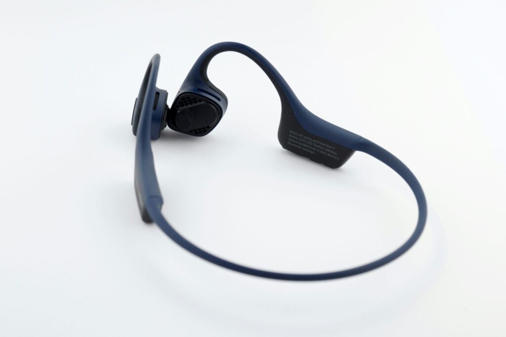 A pair of bone conduction headphones sitting against a white background