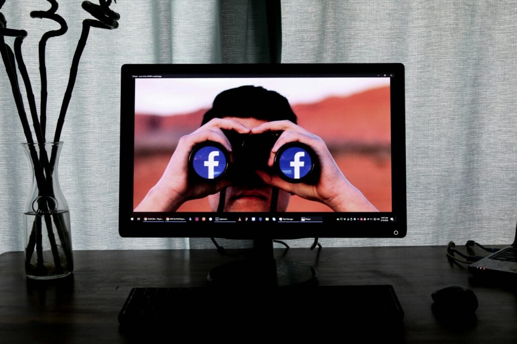 man with facebook binoculars on screen