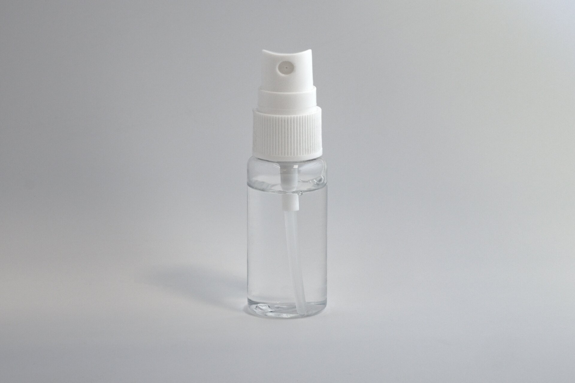 Small spray bottle filled with clear liquid